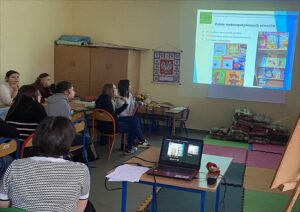 Studentki oglądają prezentację na ekranie.
